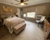 Bedroom featuring crown molding, a baseboard radiator, cooling unit, ceiling fan, and light hardwood / wood-style floors