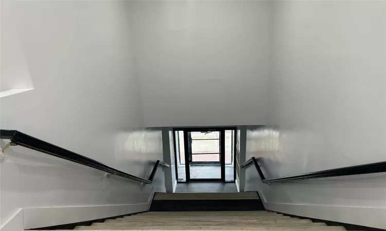 Stairs featuring hardwood / wood-style flooring