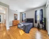 Bedroom featuring baseboard heating and light wood-type flooring