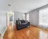 Living room featuring baseboard heating and light hardwood / wood-style floors