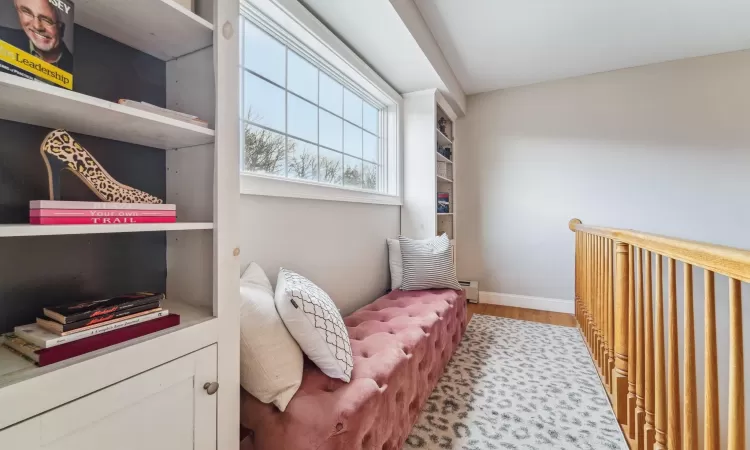 Living area with a baseboard radiator and light hardwood / wood-style floors