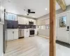 Kitchen featuring backsplash, a healthy amount of sunlight, appliances with stainless steel finishes, and white cabinets