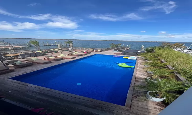 View of swimming pool with a water view