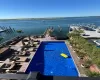 View of pool with a water view and a boat dock