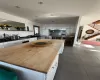 Kitchen featuring wood counters, dark tile patterned floors, a kitchen island, and white cabinets