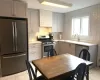 Kitchen featuring stainless steel appliances, tasteful backsplash, gray cabinets, and light tile patterned floors