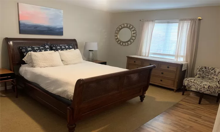 Bedroom with light hardwood / wood-style flooring