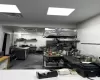 Kitchen with concrete floors and a drop ceiling