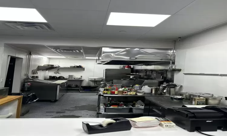 Kitchen with concrete floors and a drop ceiling