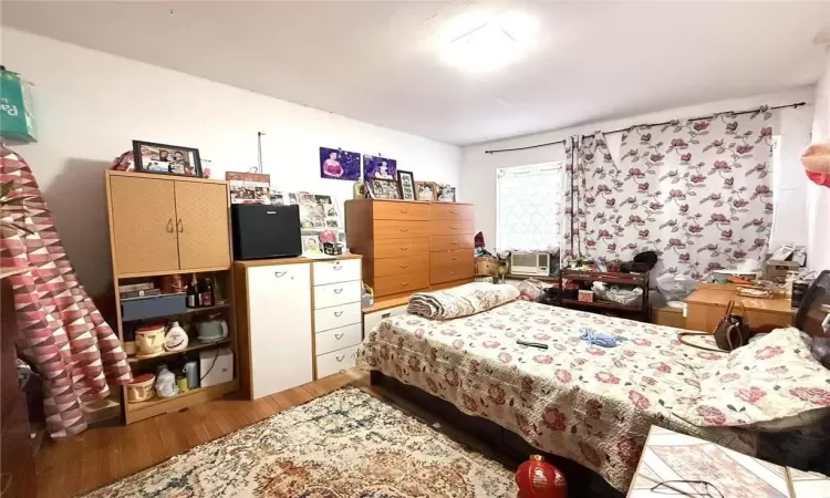 Bedroom featuring wood-type flooring