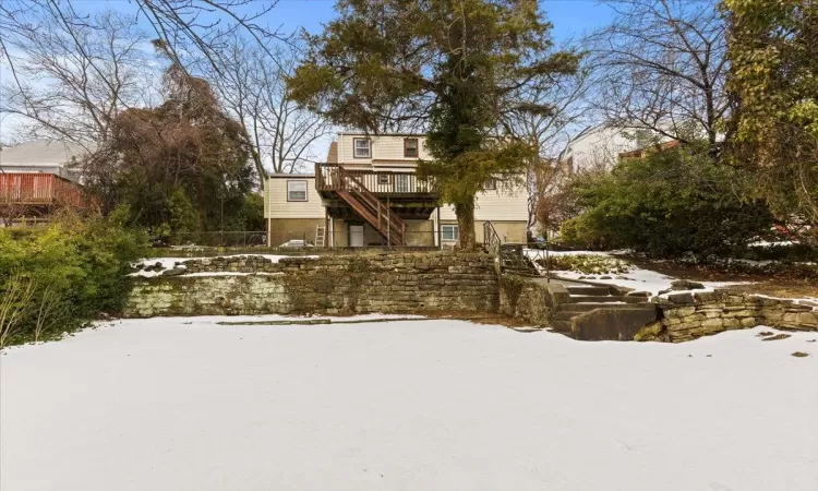 Snow covered property featuring a deck