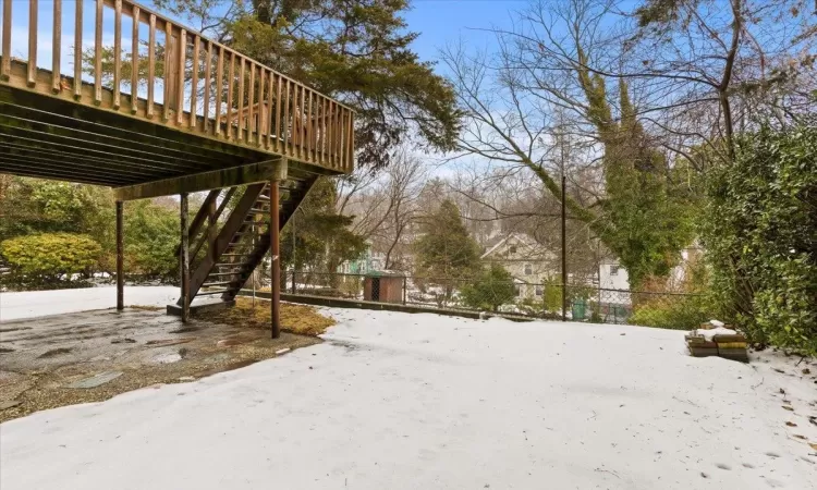 Snowy yard with a wooden deck