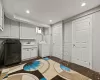 Clothes washing area featuring cabinets, washing machine and dryer, and sink