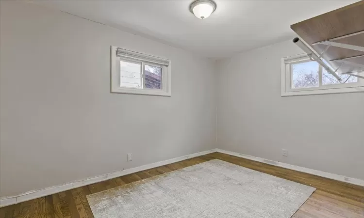 Unfurnished room with hardwood / wood-style floors