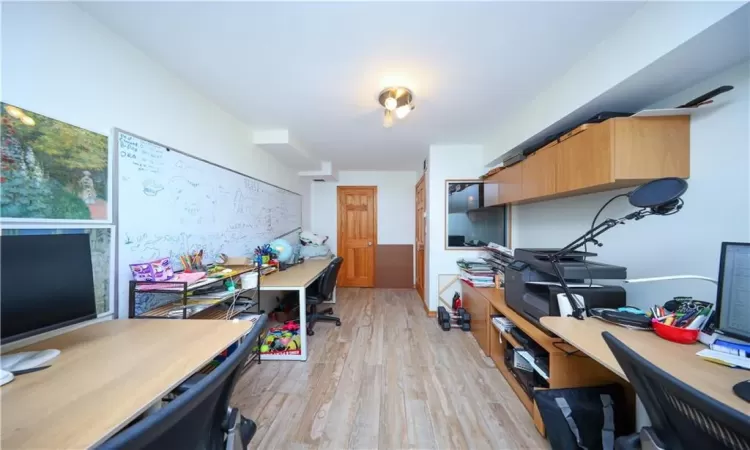 Office area with light hardwood / wood-style floors