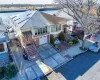 View of front of home featuring a garage, solar panels, and a water view