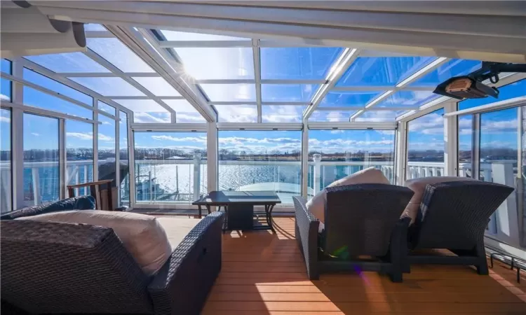 Sunroom featuring a water view