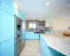 Kitchen with appliances with stainless steel finishes, sink, decorative backsplash, and wall chimney range hood