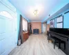 Entrance foyer with light hardwood / wood-style flooring, a chandelier, and wood walls