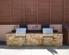 View of patio with an outdoor kitchen and a grill