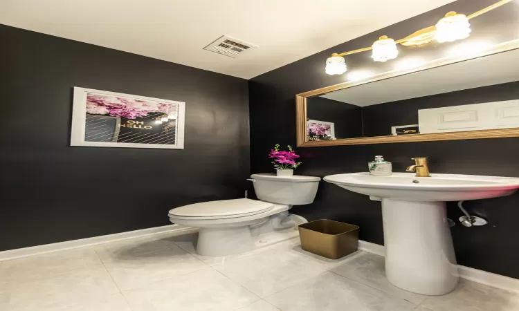 Bathroom with toilet and tile patterned flooring