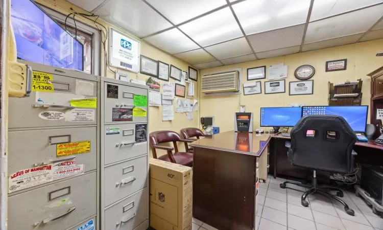 Tiled office space with a paneled ceiling