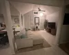 Living room featuring ceiling fan, a baseboard radiator, lofted ceiling, and light hardwood / wood-style flooring