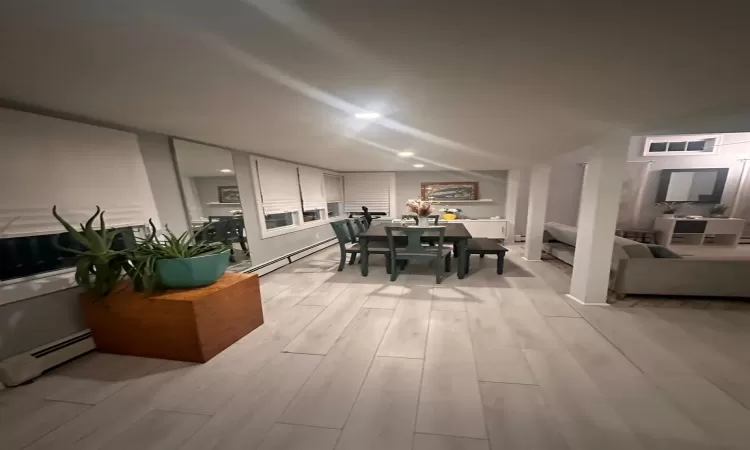 Dining area with a baseboard heating unit and light wood-type flooring