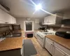 Kitchen with sink, white gas range oven, and white cabinets