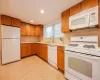 Kitchen with white appliances and sink