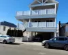 Coastal home featuring a carport and a balcony