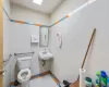 Bathroom featuring tile walls, tile patterned floors, and toilet