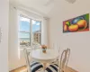 Dining room with light hardwood / wood-style floors and a water view