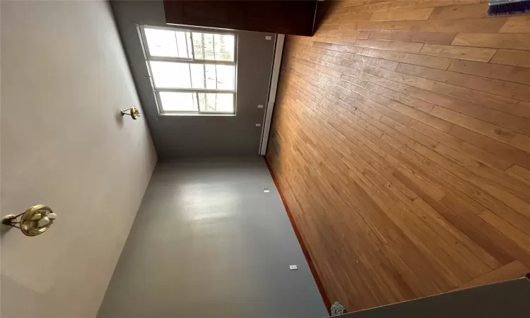 Spare room with a baseboard heating unit and light wood-type flooring