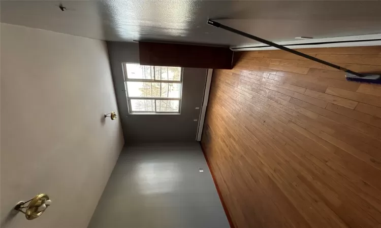 Empty room featuring baseboard heating and light wood-type flooring