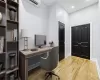 Office featuring a wall unit AC and light hardwood / wood-style flooring