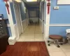 Hallway featuring light tile patterned floors and a paneled ceiling