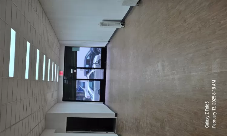 Unfurnished room featuring hardwood / wood-style flooring, a paneled ceiling, and radiator heating unit