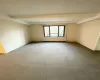 Spare room featuring carpet floors and beam ceiling