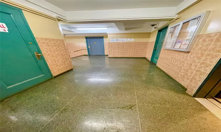 Hallway with tile walls