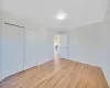 Unfurnished bedroom featuring light wood-type flooring and a closet