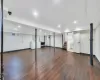 Basement with washing machine and dryer and dark hardwood / wood-style floors