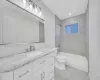 Full bathroom with toilet, vanity, and tiled shower / bath