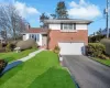 View of front facade with a garage and a front yard