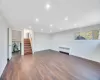 Unfurnished living room with radiator and dark wood-type flooring