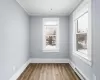 Empty room featuring crown molding, dark hardwood / wood-style floors, and a baseboard radiator