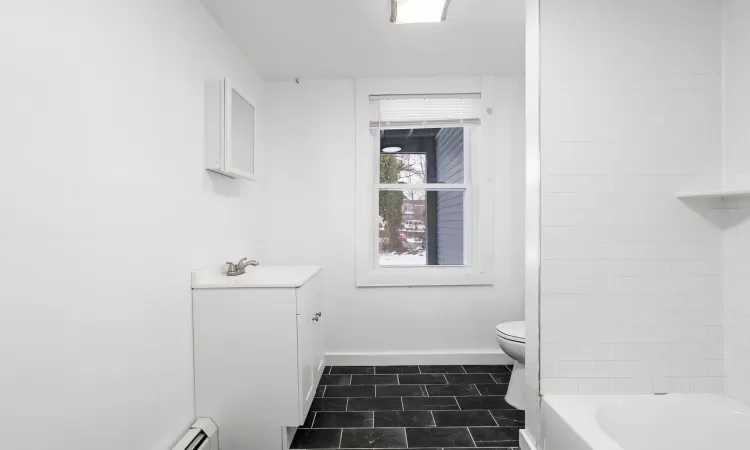 Bathroom featuring tile patterned floors, toilet, and vanity