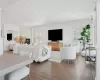 Living room featuring plenty of natural light, ornamental molding, and a fireplace