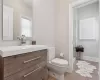 Bathroom with vanity, toilet, and hardwood / wood-style floors