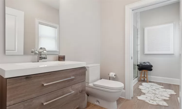 Bathroom with vanity, toilet, and hardwood / wood-style floors